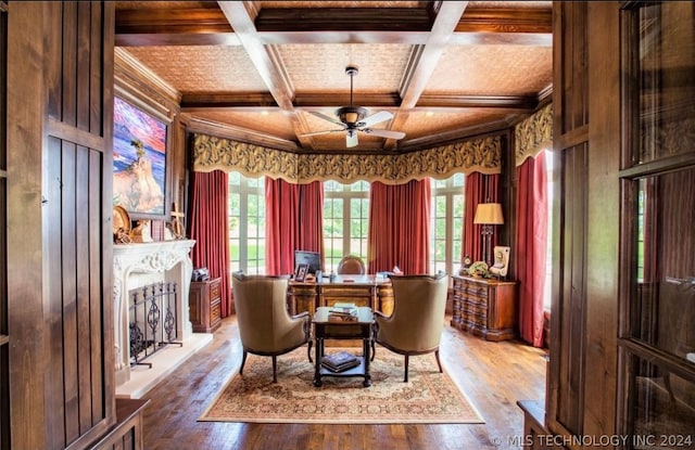 dining space with coffered ceiling, hardwood / wood-style flooring, and a healthy amount of sunlight