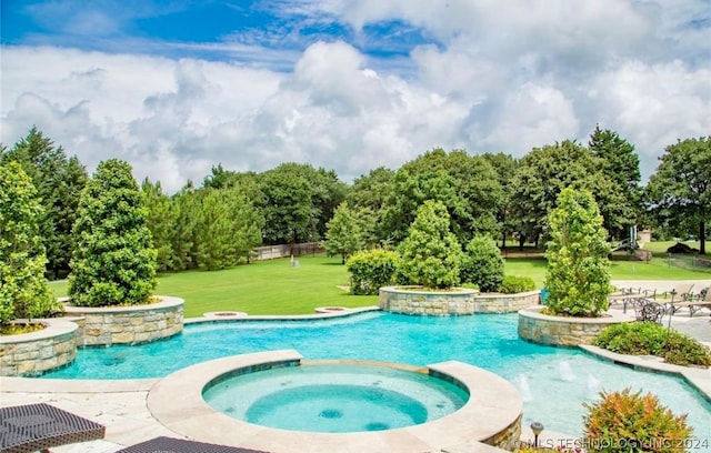 view of swimming pool featuring an in ground hot tub and a lawn