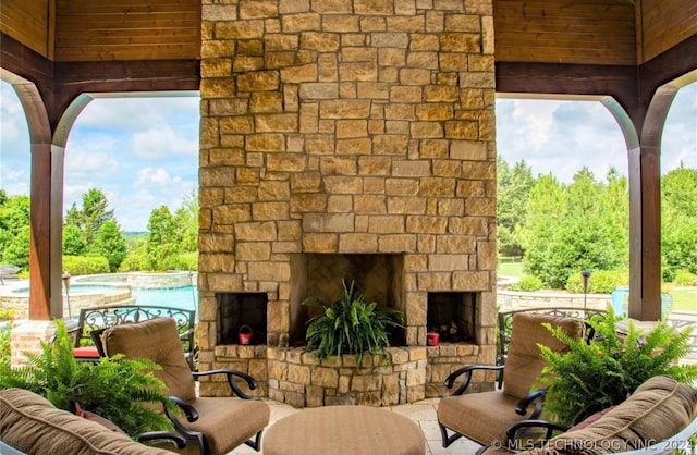 view of patio / terrace with an outdoor stone fireplace