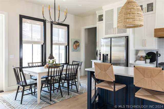 dining area featuring a chandelier and light wood-type flooring