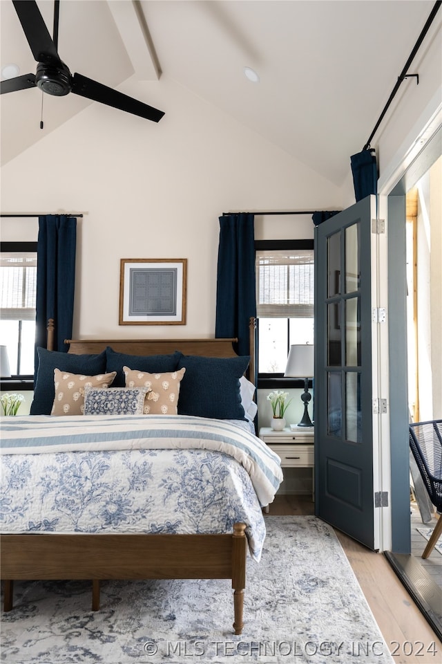 bedroom featuring vaulted ceiling with beams, ceiling fan, and light wood-type flooring