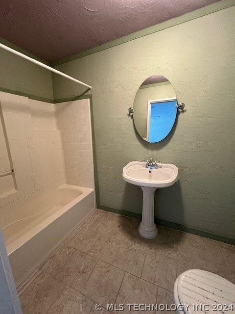 bathroom featuring shower / bath combination, tile floors, and toilet