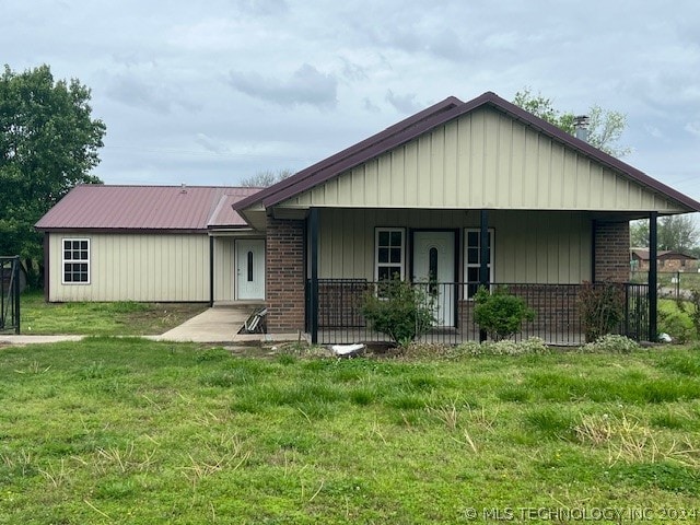 exterior space featuring a porch and a lawn