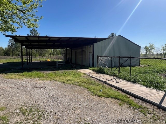 view of outdoor structure featuring a lawn and a carport