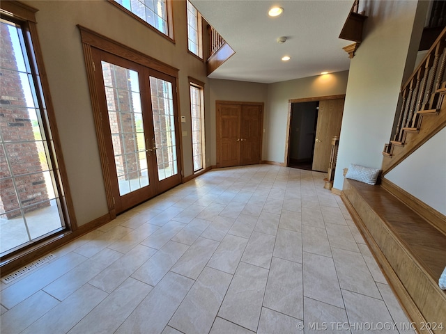 foyer entrance with french doors and light tile floors