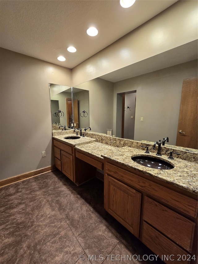 bathroom featuring dual bowl vanity and tile floors