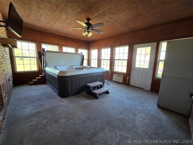 unfurnished bedroom with a wall mounted air conditioner, dark carpet, and ceiling fan