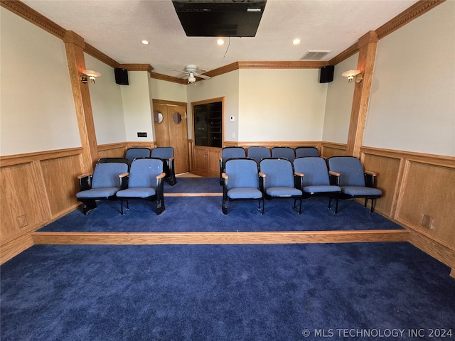 home theater featuring ceiling fan, dark carpet, and crown molding