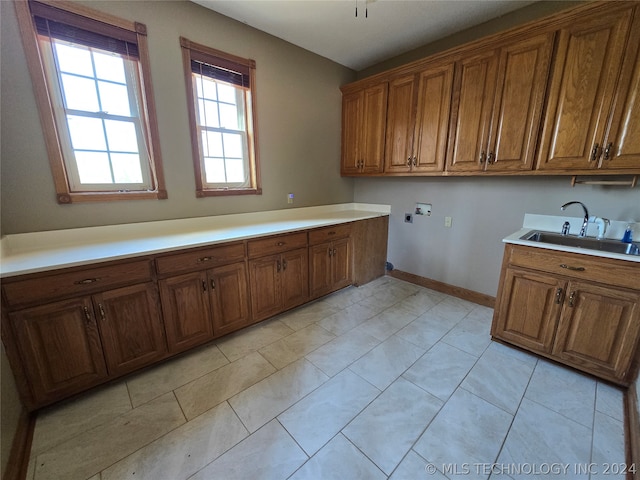 kitchen featuring sink and light tile floors