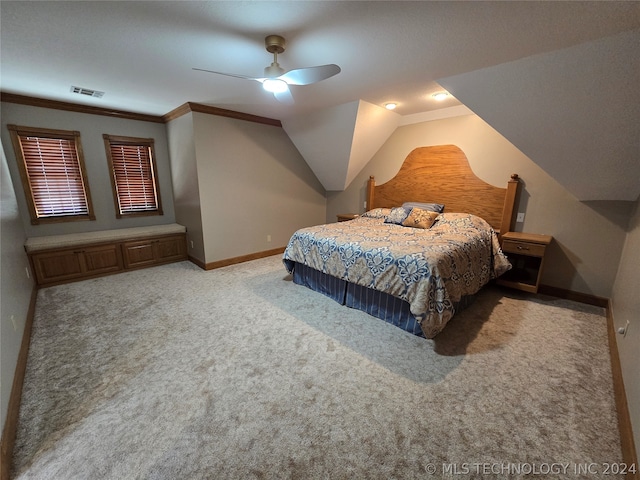 bedroom with ornamental molding, light colored carpet, ceiling fan, and vaulted ceiling