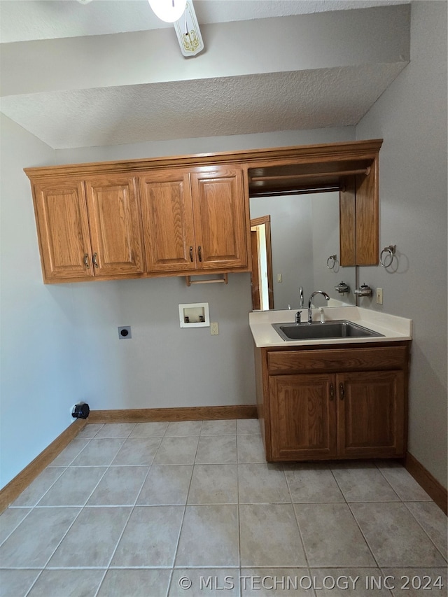 interior space with sink, light tile floors, and a textured ceiling