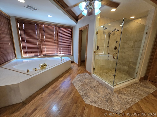 bathroom with ceiling fan, hardwood / wood-style flooring, and separate shower and tub