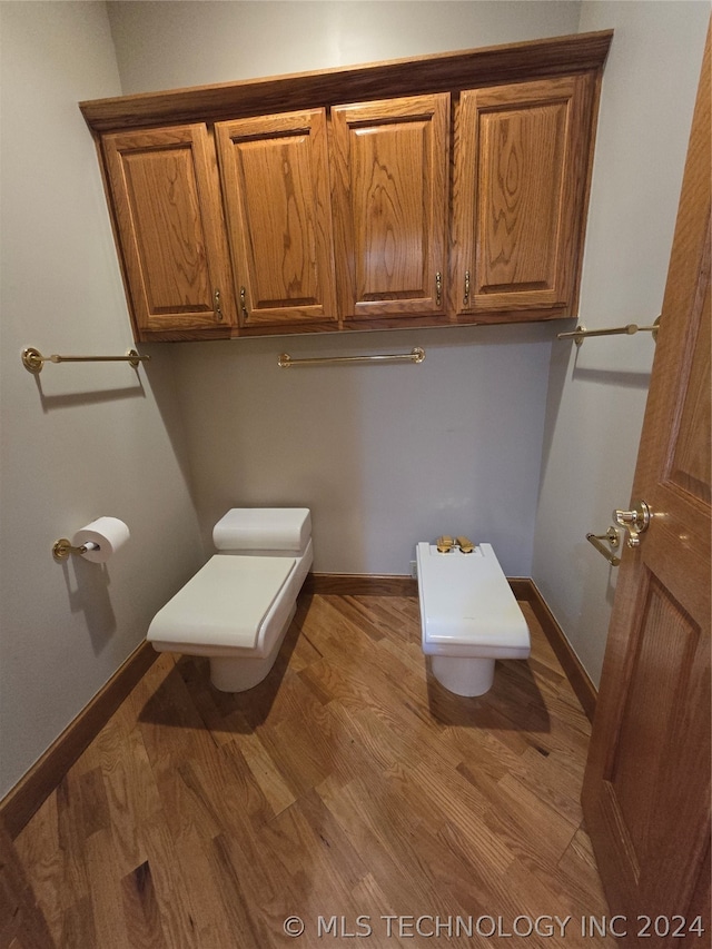 bathroom with wood-type flooring and toilet