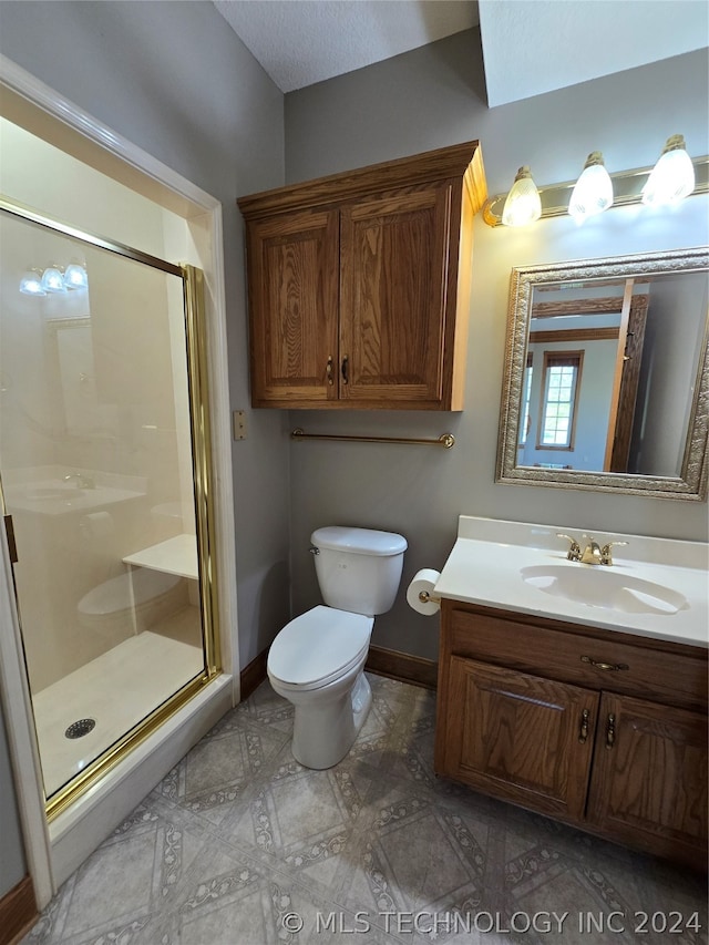 bathroom with a textured ceiling, tile floors, toilet, vanity, and a shower with door