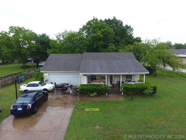 view of front of property with a garage, a porch, and a front yard