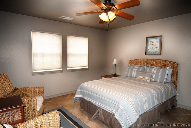 bedroom featuring ceiling fan and light tile floors