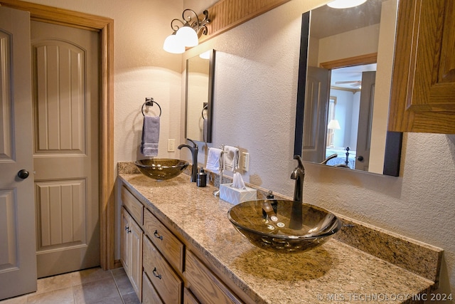 bathroom featuring dual sinks, tile floors, and oversized vanity