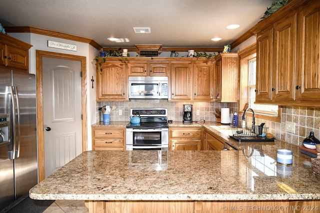 kitchen featuring light stone counters, appliances with stainless steel finishes, sink, backsplash, and crown molding