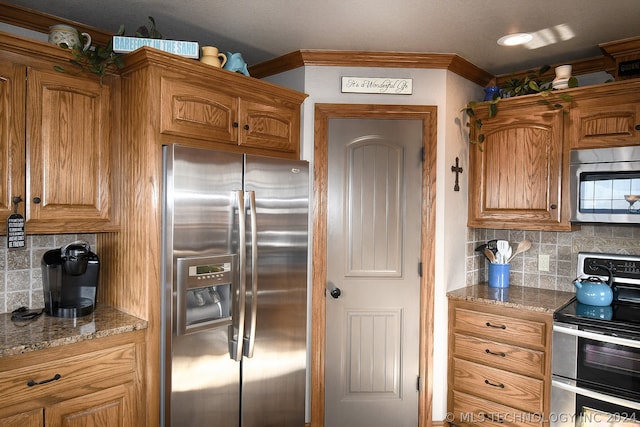 kitchen featuring dark stone countertops, tasteful backsplash, and stainless steel appliances