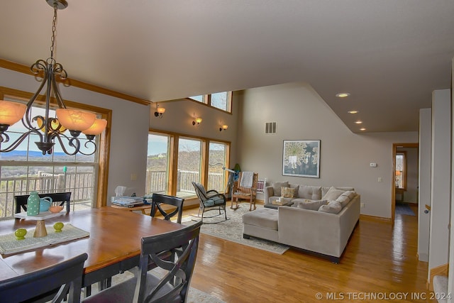 dining area featuring light hardwood / wood-style flooring and a notable chandelier