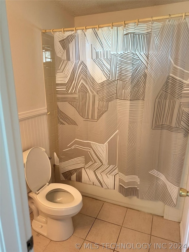 bathroom with tile patterned flooring and toilet