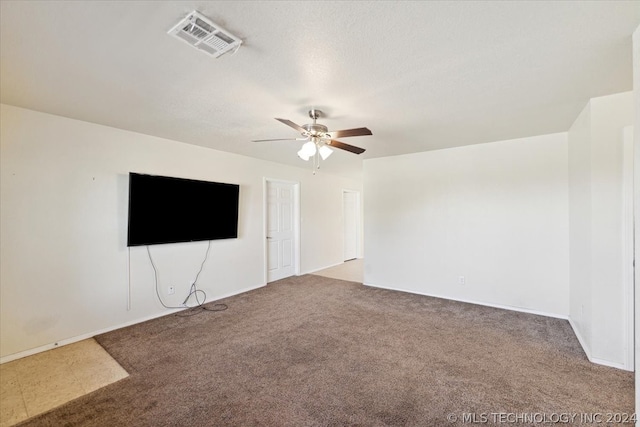 spare room with light colored carpet and ceiling fan