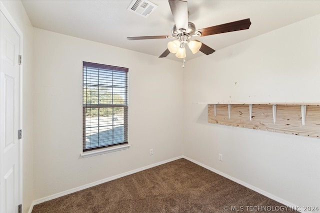 spare room featuring ceiling fan and carpet floors