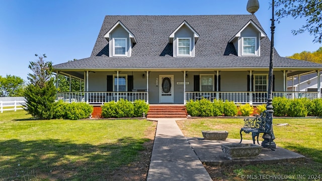 view of front facade with a front yard and covered porch