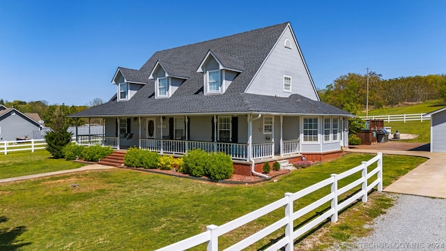 farmhouse inspired home featuring a front yard and a porch