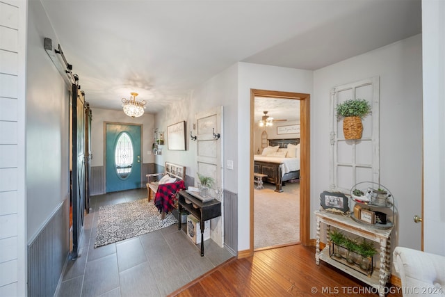 entrance foyer with a barn door and dark hardwood / wood-style flooring