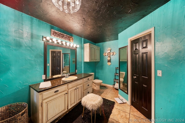 bathroom featuring vanity, tile floors, and toilet