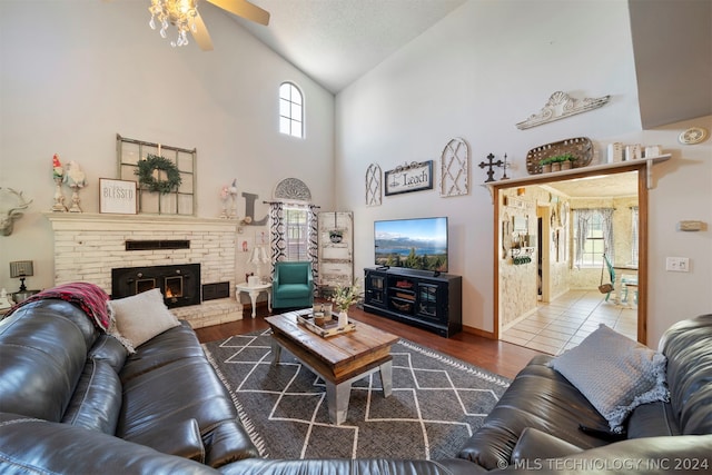 living room with ceiling fan, a wealth of natural light, and dark wood-type flooring