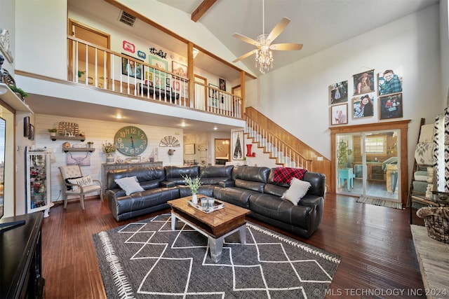 living room featuring beamed ceiling, dark hardwood / wood-style floors, high vaulted ceiling, and ceiling fan