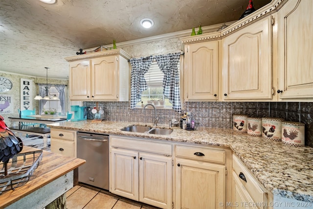 kitchen featuring light stone countertops, tasteful backsplash, sink, pendant lighting, and stainless steel dishwasher