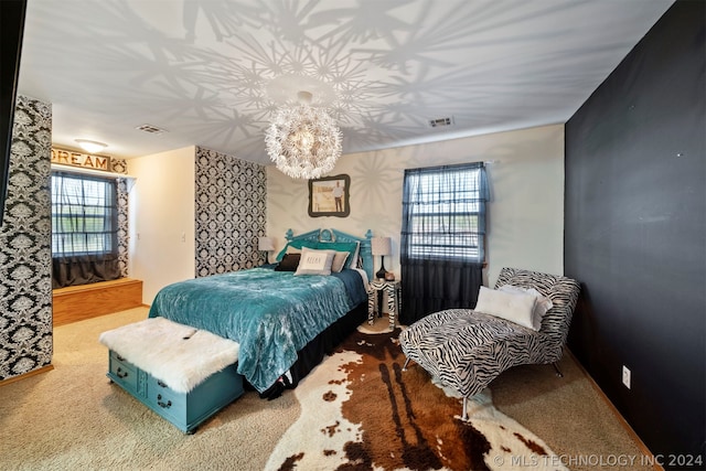 carpeted bedroom featuring a chandelier and multiple windows