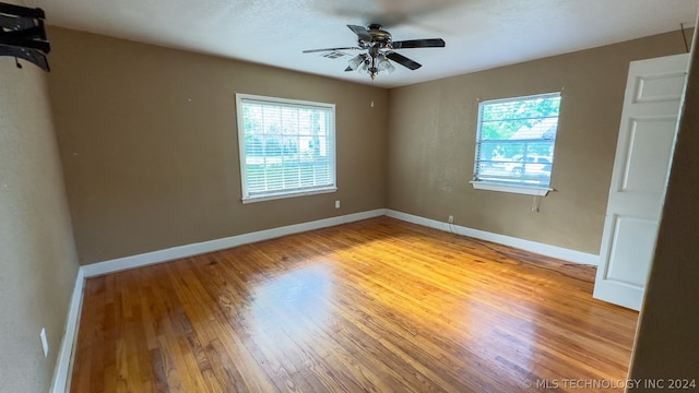 spare room with light hardwood / wood-style floors and ceiling fan