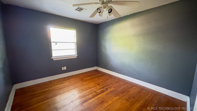 spare room with wood-type flooring and ceiling fan