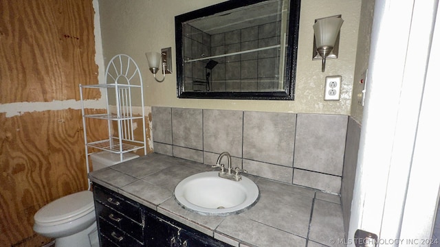 bathroom featuring vanity with extensive cabinet space and toilet