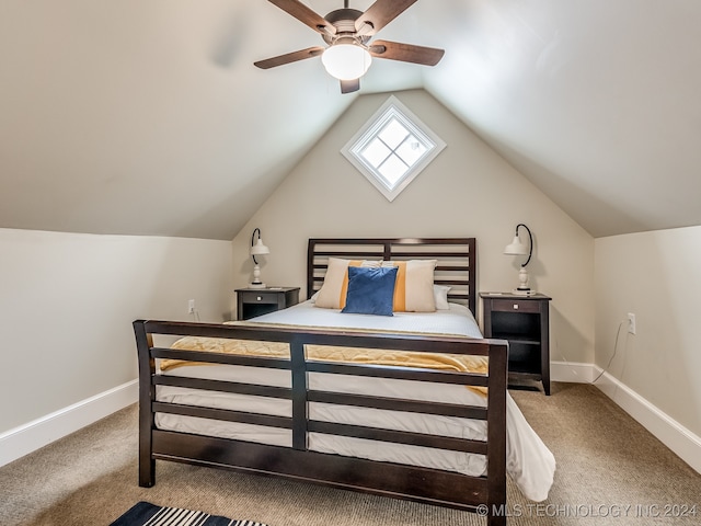 bedroom with light carpet, vaulted ceiling with skylight, and ceiling fan