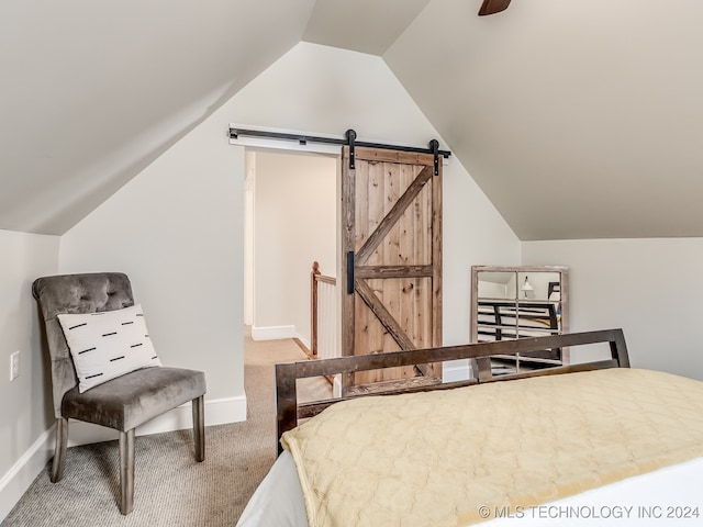 bedroom with carpet, vaulted ceiling, a barn door, and ceiling fan