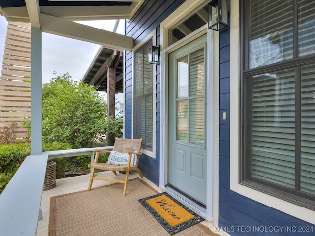 view of exterior entry with a porch