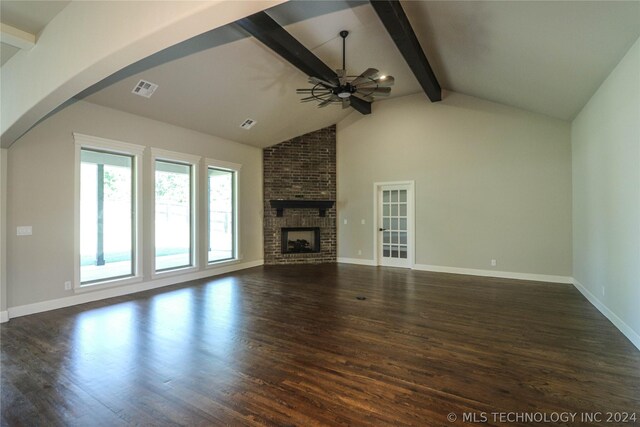 unfurnished living room featuring ceiling fan, beam ceiling, dark hardwood / wood-style flooring, and a brick fireplace