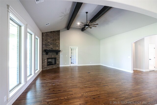 unfurnished living room featuring dark wood-type flooring, ceiling fan, high vaulted ceiling, a fireplace, and beamed ceiling