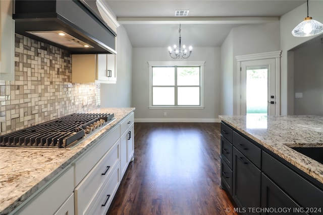 kitchen featuring white cabinetry, hanging light fixtures, range hood, and stainless steel gas cooktop