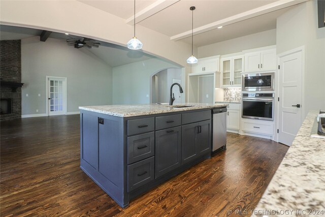 kitchen with sink, white cabinetry, appliances with stainless steel finishes, pendant lighting, and ceiling fan