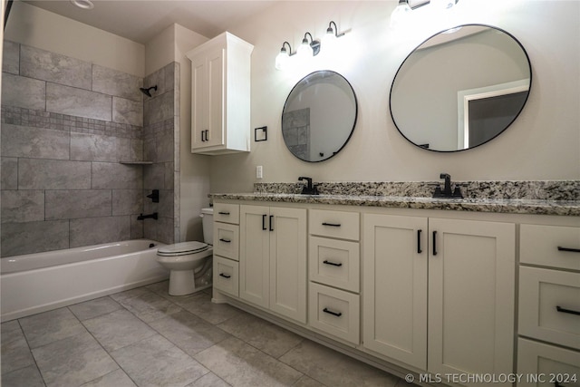 full bathroom featuring tiled shower / bath, vanity, and toilet