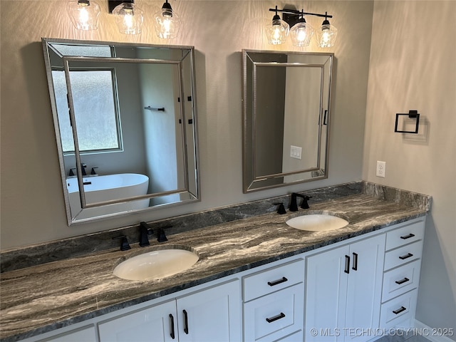 bathroom with vanity and a bath