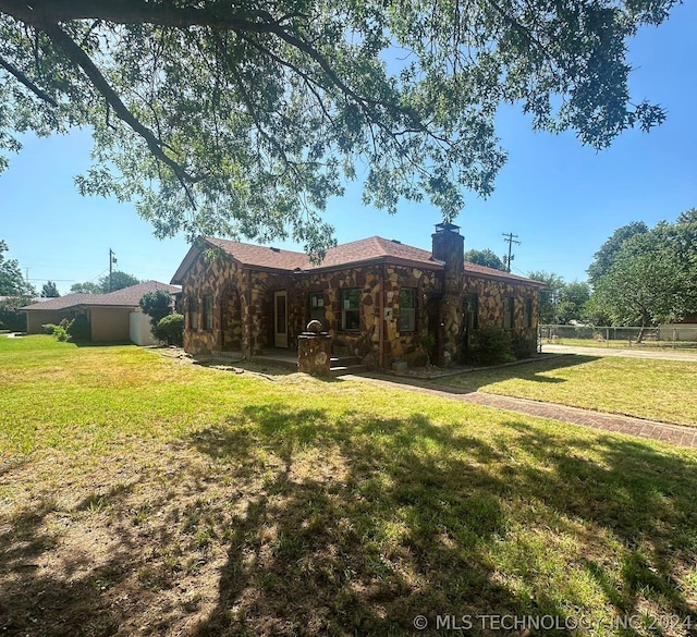 back of property with a lawn