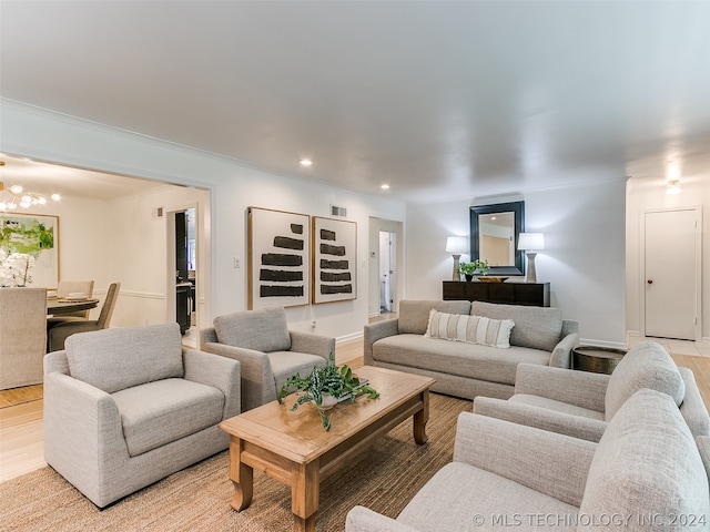 living room with a chandelier and light wood-type flooring