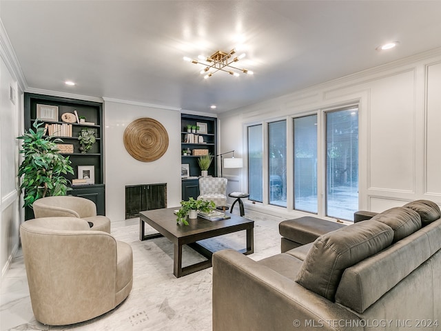 living room with a fireplace, crown molding, an inviting chandelier, and built in shelves